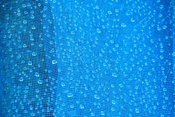 Water drops on the blue net