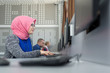 © Myvisuals - Arabic business woman working in team with her colleagues at off