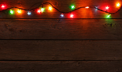 christmas lights border on wood background