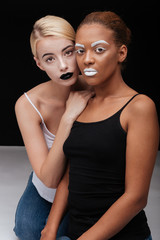 Wall Mural - Portrait of african and caucasian girls with fashion makeup