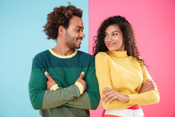 Wall Mural - Smiling young couple standing and looking at each other