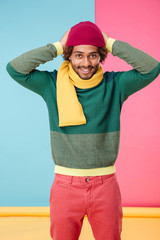 Sticker - Smiling african american young man wearing hat and scarf