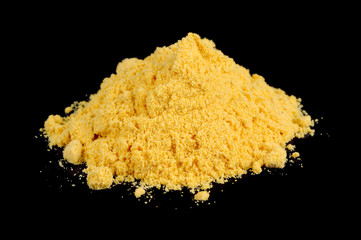 Canvas Print - A pile of mustard powder against a black background