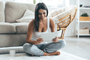 Wall Mural - Examining her brand new tablet. 