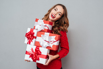 Poster - Happy young woman with christmas gifts