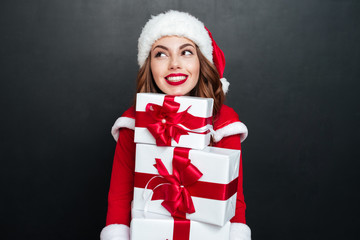 Poster - Woman in red dress holding stack of presents