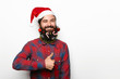 © kegfire - happy man with beard and christmas decorations showing thumb up