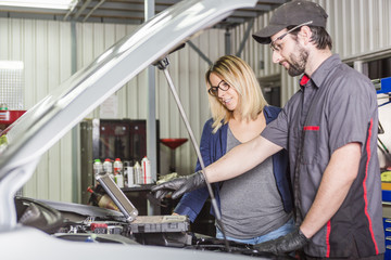 auto mechanic and female customer in garage