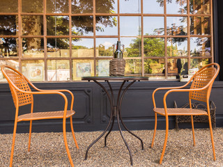 Coffee table and two chair in front of glass wall, vintage style