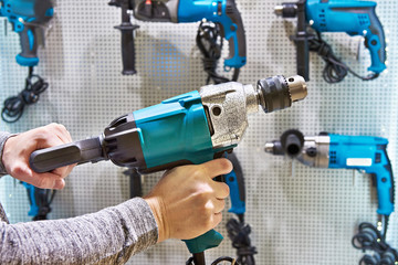 Hammer drill in man's hands