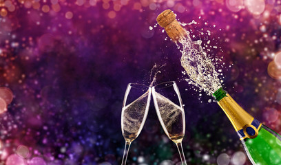 Wall Mural - Bottle of champagne with glasses over fireworks background