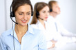 © rogerphoto - Call center. Focus on beautiful woman in headset