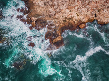 Aerial View Of Rocky Coastline And Crashing Waves