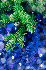 Wall Mural - Blue Christmas bauble with pine on a sparkling background