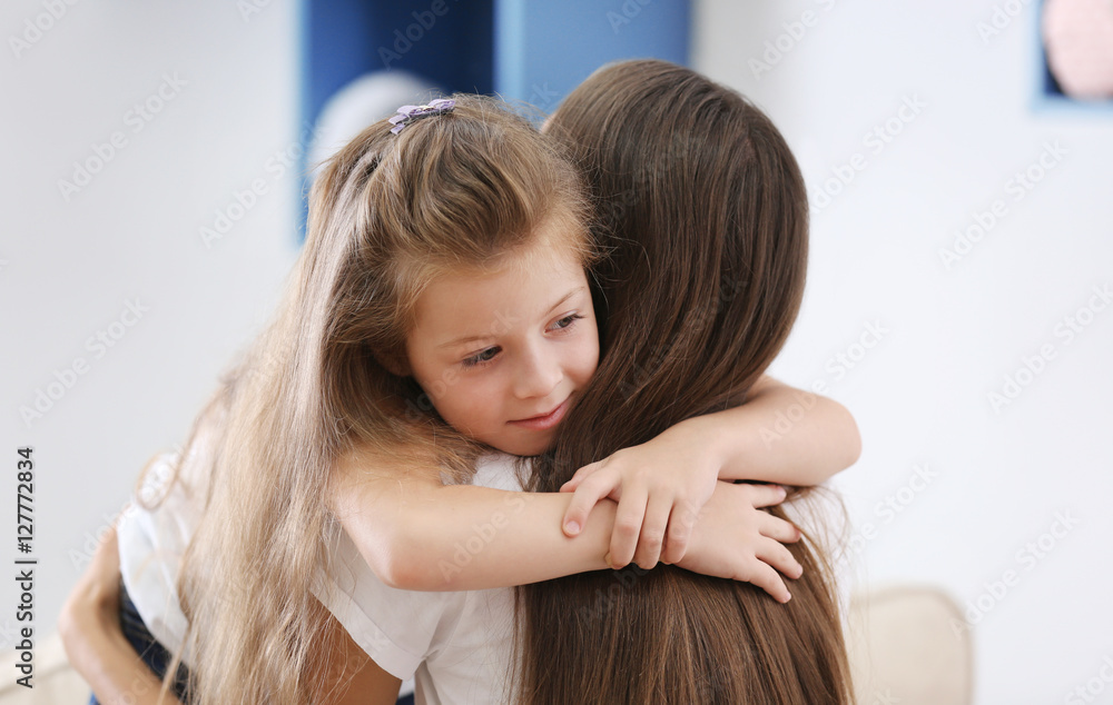 Cute girl with mother at home