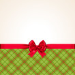 Hintergrund für Weihnachten / Weihnachtskarte mit roter Schleife und kariertem Stoff