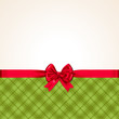 traditioneller Hintergrund für Weihnachten mit roter Schleife und grünem Karo