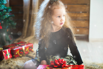 Wall Mural - Little girl and gift in Christmas decor. Dream.