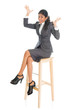 © WONG SZE FEI - Happy black businesswoman seated on chair.