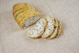 Fototapeta Kuchnia - Fresh whole grain bread cut in half on white background