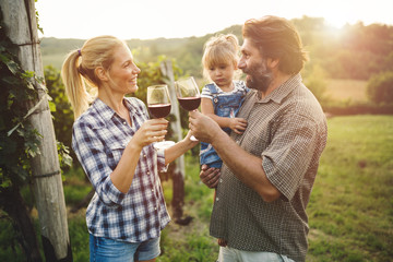 Wall Mural - Winegrower family tasting wine