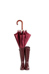 rubber boots and umbrella stick color marsala on isolated backgr