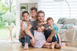 © jackfrog - At home,  cheerful family sitting on floor in the living-room.