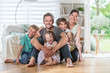 © jackfrog - At home,  cheerful family sitting on floor in the living-room.