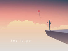 Businessman Standing On A Cliff Letting Go  Balloon.