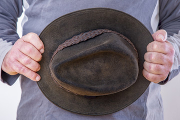 Man is holding scared hat