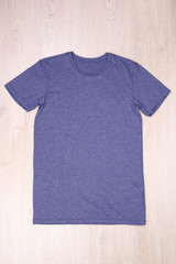 Poster - Dark blue gray t-shirt on wooden background