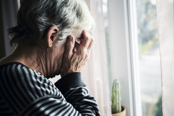 worried senior woman at home felling very bad