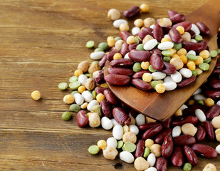 Wall Mural - mix of beans ( peas, lentils) on a wooden table