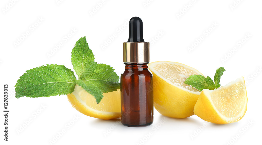 Beautiful spa composition with lemon essential oil on white background, closeup