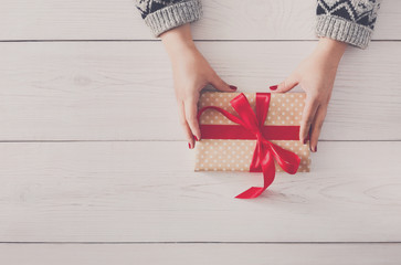 Wall Mural - Woman's hands give christmas gift in present box