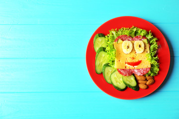 Plate with tasty food on wooden background, top view