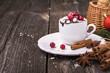 Mug cupcake New Year Christmas with marshmallow and juicy cranberries on a wooden background  toys  pine branches. Holiday breakfast