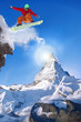 © Tomas Marek - Snowboarder jumping against Matterhorn peak in Switzerland