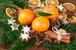 mandarins fruits with fir branch and christmas spices on wooden table