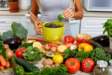 Wall Mural - Hands of woman with bowl and salad.