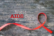 Red ribbon awareness on aged wood background: World aids day: Symbolic concept for raising awareness campaign on people with HIV concept
