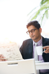 Wall Mural - indian male drinking at cafe