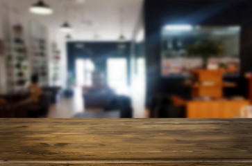 Selected focus empty brown wooden table and Coffee shop blur bac