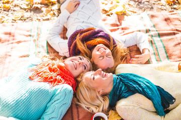 Happy friends having fun in beautiful autumn park. Pretty women in fall time