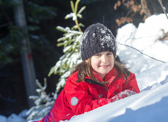 Little girl have a nice day on the snow