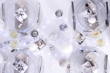 bright white and silver new year eve or christmas table in a luxury restaurant with champagne