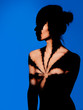 © Pavel_A - Beauty naked woman portrait. Light spot form like marijuana leaf. Blue backdrop.