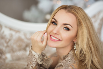 portrait of pretty young woman in evening dress smiles in christmas