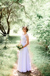 © IVASHstudio - young beautiful bride in a white dress standing alone outdoors