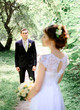 © IVASHstudio - young and beautiful bride and groom standing in the garden